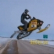 Snow mobile jumps over road